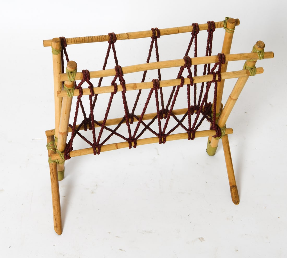 CZECH BAMBOO & CORD MAGAZINE RACK C. 1970S: Bamboo frame and diagonally interlaced cord with rattan. Czechoslovakia, circa 1970s. Dimensions: H 28.5" x W 17.5" x D 9.5" Condition: Wear consistent with age and use. Darkening and patina on bamboo
