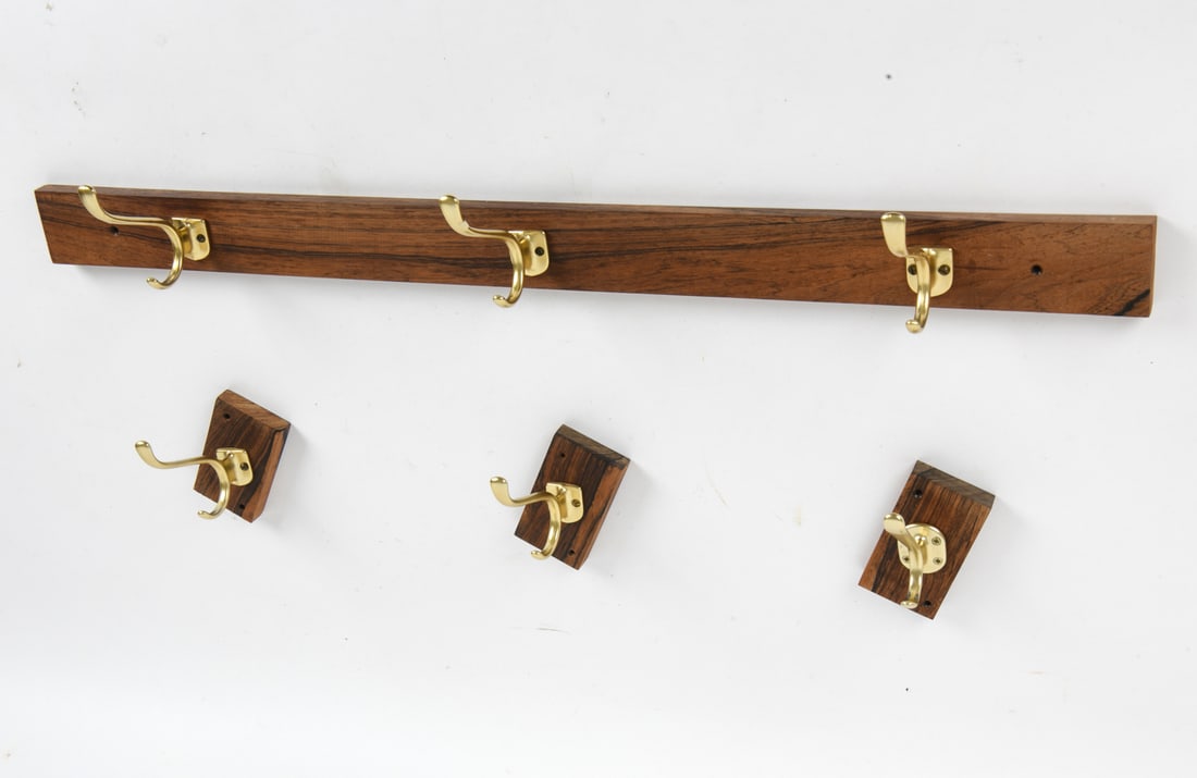 ADOLF LOOS STYLE ROSEWOOD & BRASS COAT HOOKS: Features a long coat rack with three brass hooks and three single mounts with a single hook on each. All meant to be mounted to the wall. Czechoslovakia, circa 1950s. Dimensions: (Largest) H 4.5" x W