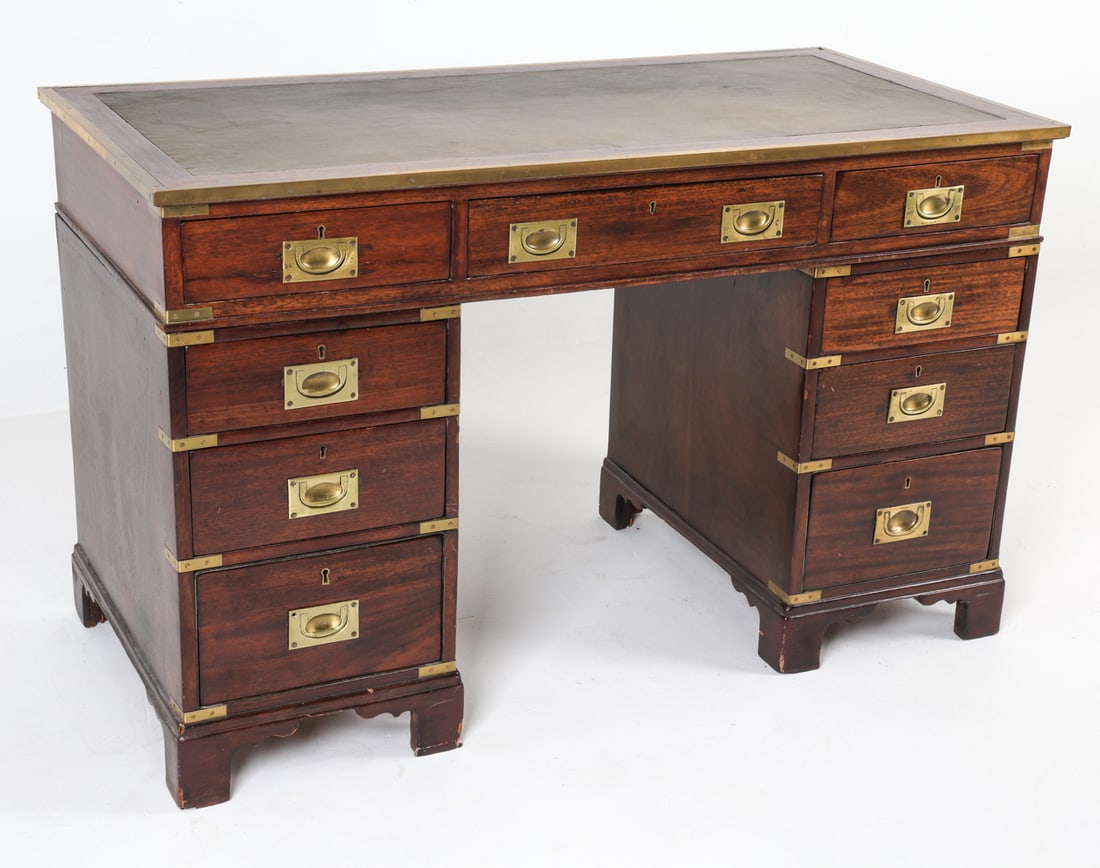 MAHOGANY AND BRASS CAMPAIGN DESK: Dimensions: H 30" x W 48" x D 23" Condition: With patination to brass and leather top. Few water marks, scratches and scuffs to finish consistent with age and use.