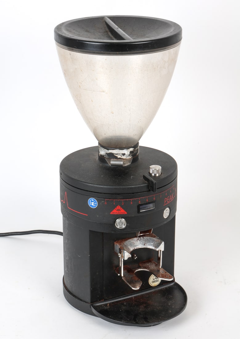 MAHLKONIG PEAK COFFEE GRINDER: Labeled front. Dimensions: H 22" x W 11" x D 9" Condition: Showing signs of wear consistent with age and use.
