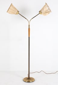 Brass floor lamp with (2) adjustable necks with beech accent to stand. Scandinavian, circa 1960s.