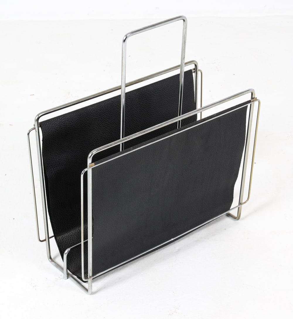 DANISH STEEL & LEATHER MAGAZINE RACK C. 1960S: Denmark, circa. 1960s. Dimensions: H 19.25" x W 17.75" x D 7.25" Conditions: Fading and rubs to leather. Wear consistent with age and use. DMS005