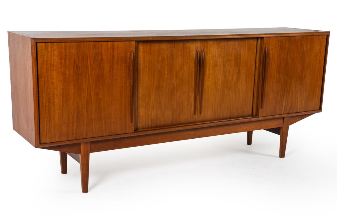 MANNER OF SVEND MADSEN DANISH TEAK SIDEBAORD 1960S: Teak sideboard in the manner of Svend Madsen. Adjustable shelves. Felt-lined drawers. Denmark, circa 1960s. Dimensions: H 33.5" x W 78.75" x D 17" Conditions: Dings and scratches to surface and sides,