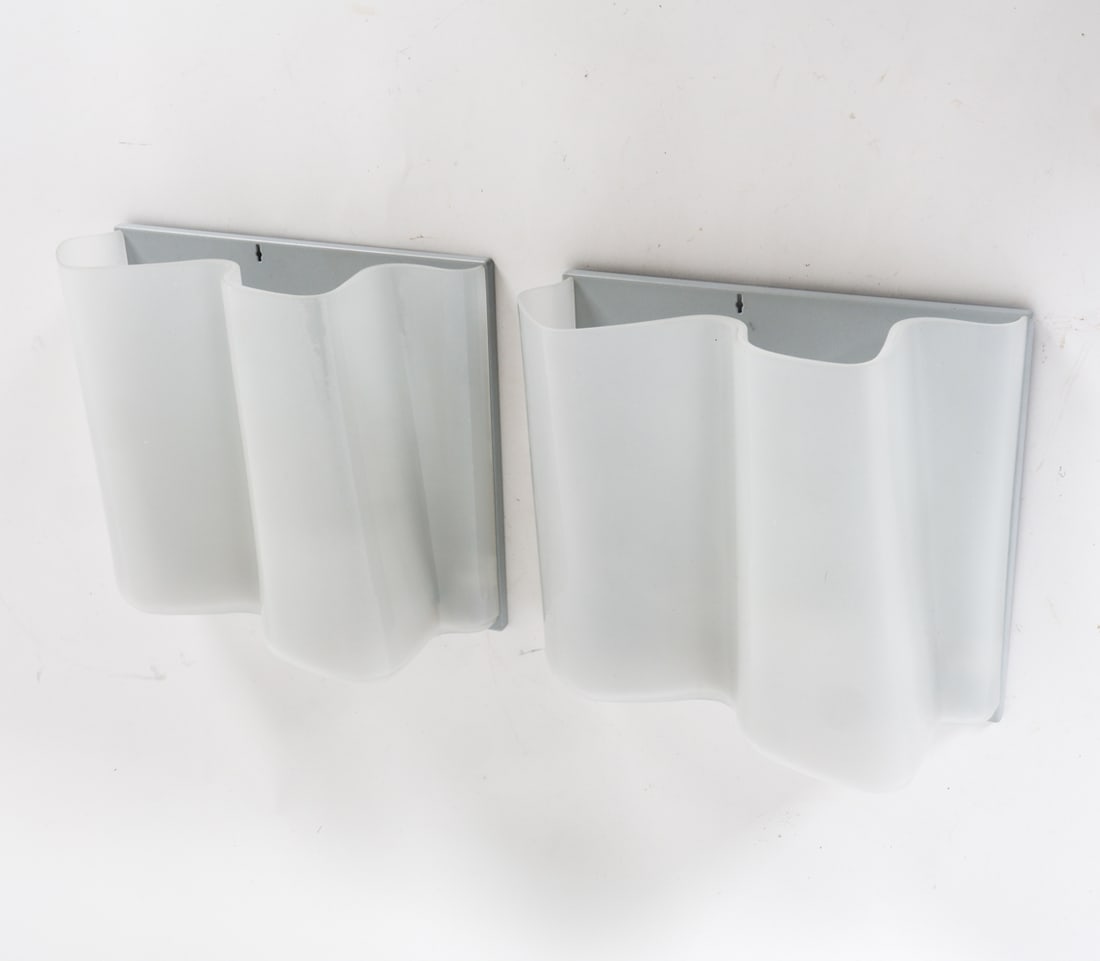 PAIR OF ARTEMIDE LOGICO GLASS SCONCES: Designed by Michele De Lucchi and Gerhard Reichart. Hand-blown glass with satin finish. Tagged to wall bracket. Contemporary. Dimensions: H 9" x W 9.5" x D 4.25". Condition: Wiring untested. Minor scu