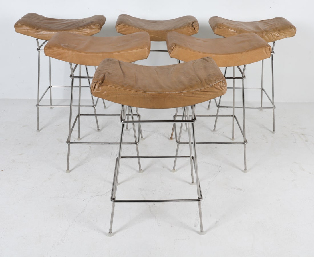 (6) FERNANDO JAEGER BIENAL LEATHER BAR STOOLS: Tan leather upholstery with stainless steel legs. Brazil, circa 1990s. Dimensions: H 30" x W 21" x D 14" x SH 28". Condition: Staining and soiling to multiple stools, crease to leather. Wear consisten