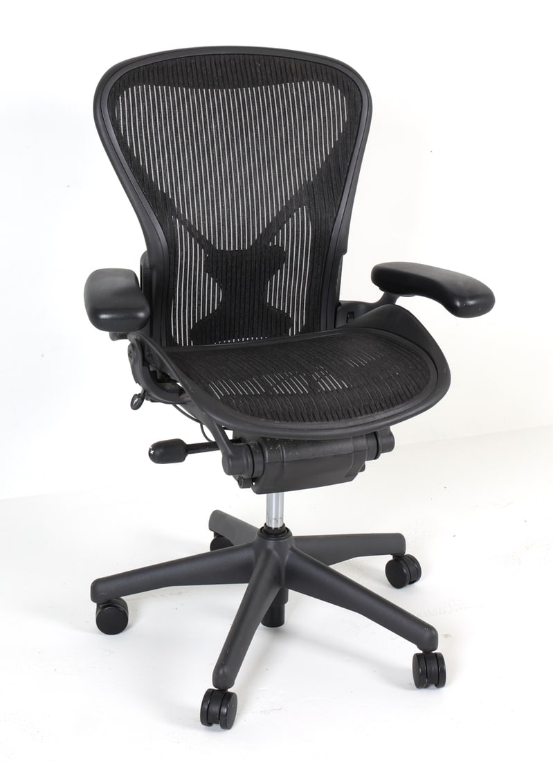 HERMAN MILLER 'AERON' OFFICE CHAIR C. 1990S: Designed by Bill Stumpf and Don Chadwick. First introduced in 1994. Marked to back of top. Size B. Adjustable height and seat angle. Dimensions: H 42" x W 25.5" x D 25" x SH 22". Condition: Minor scuf