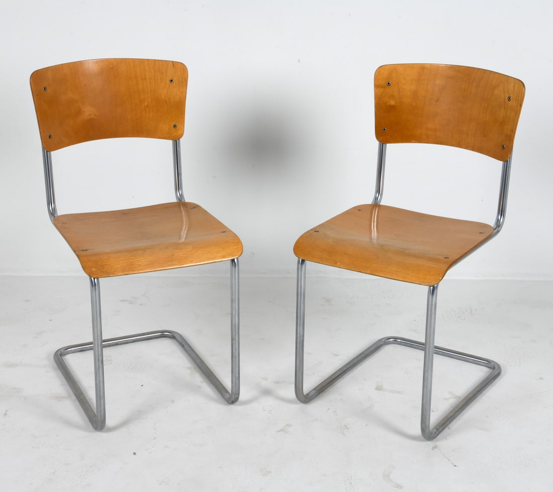 PAIR OF GISPEN BAUHAUS MODEL 108 CHAIRS C. 1950S: Features a pair of early model chairs by Gispen, marked on undersides. Steel frames with beech seating and backrests. Netherlands, circa 1950s. Dimensions: H 32.5" x W 16.5" x D 18.5" x SH 17.5" Condi