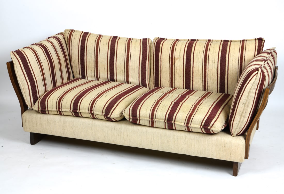 IKEA 'PERU' TWO-SEATER SOFA C. 1970S: Two-seater sofa featuring a solid wood frame with a backrest. The design includes loose cushions for the back and seat, upholstered in a light, neutral fabric in tones of beige and red. Apparently unm