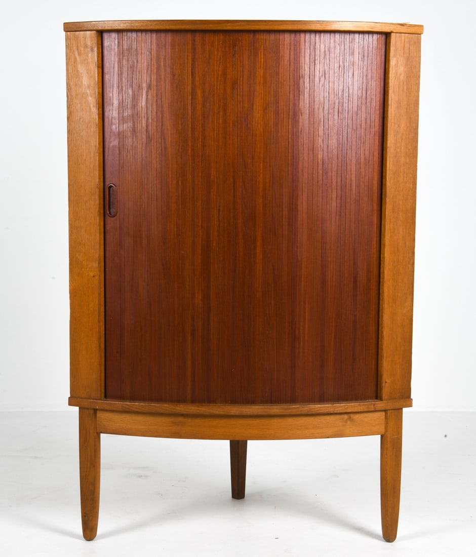 PINDEX DANISH TEAK TAMBOUR CORNER CABINET C. 1960S: Tagged to back top corner. Denmark, circa 1960s. Dimension: H 49.25" x W 33.25" x D 21.25". Conditions: Wear consistent with age and use. Few minor dings and rubs. Minor water ring to top.