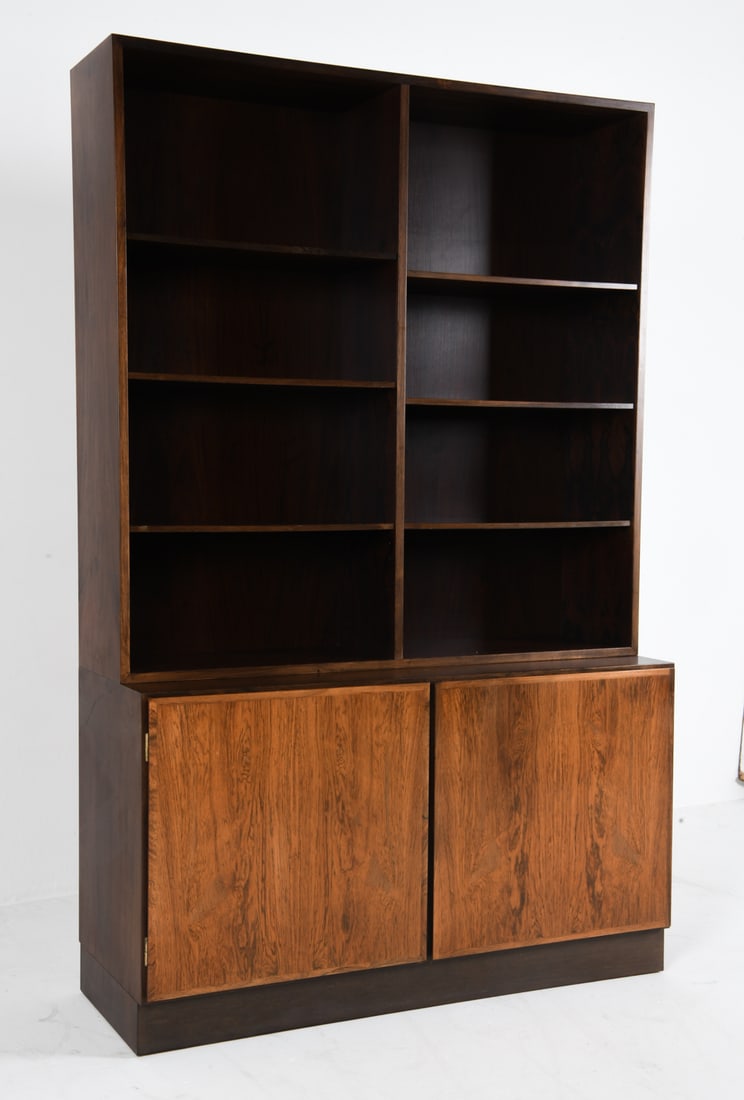 OMANN JUN MODEL 6 ROSEWOOD BOOKCASE CABINET 1960S: Bookcase sits freely on cabinet base. Tagged to backside of cabinet. Felted drawers. Adjustable shelves. Denmark, circa 1960s. Dimensions: H 74" x W 48" x D 17.5". Condition: Light scuffs, Wear consis