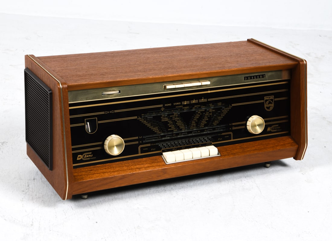 PHILIPS BI-AMPLI B5X14A TUBE RADIO C. 1960S: Table top radio in teak case. Netherlands, circa 1960s. Dimensions: H 10" x W 21.75" x D 9.5". Condition: Wiring untested, European plug. Minor scuffs to wood. Wear consistent with age and use.