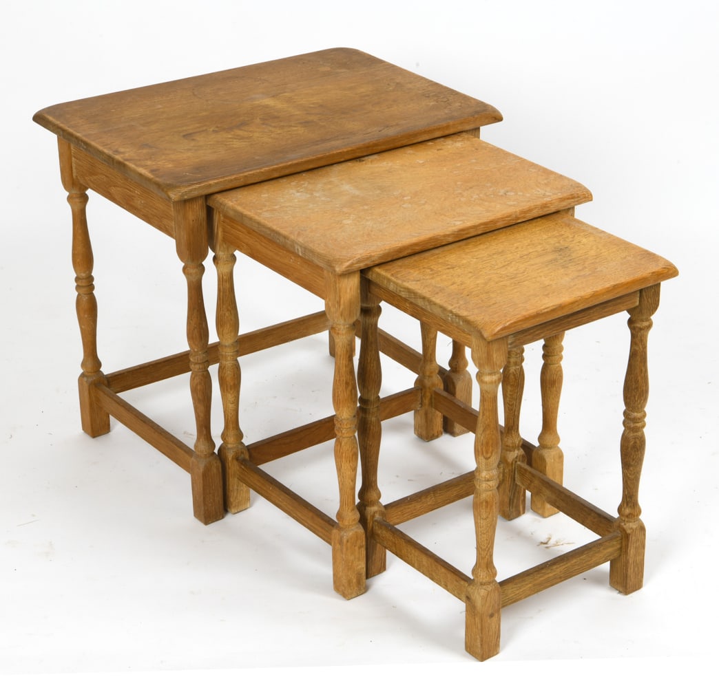 HENNING KJAERNULF STYLE DANISH OAK NESTING TABLES: Set of three oak nesting tables, in the style of Henning Kjaernulf, featuring carved legs and classic Scandinavian design. Apparently unmarked. Circa 1970s. Dimensions: H 20.5" x W 21.5" x D 15.5" Con