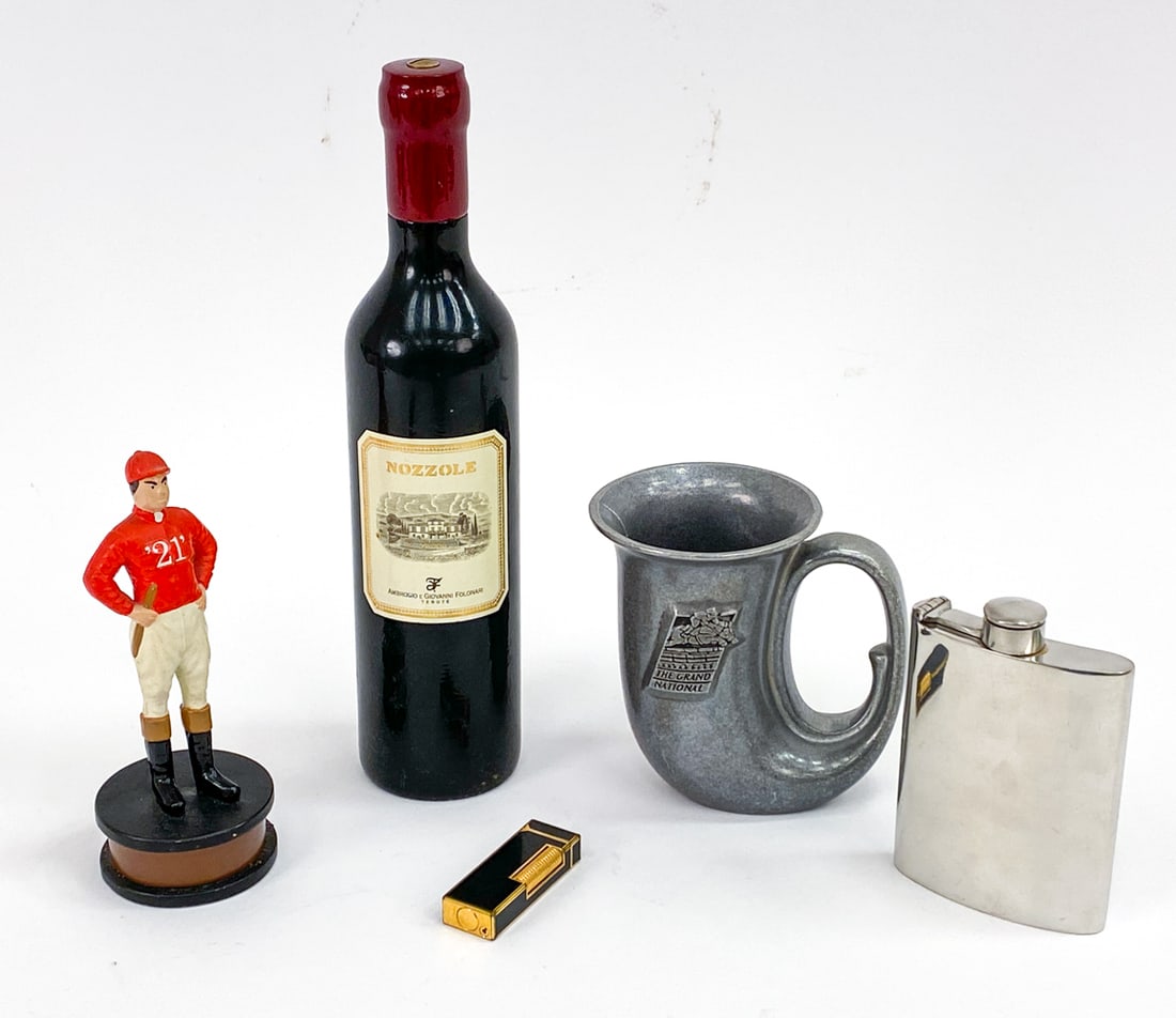 DECORATIVE GROUPING: Grouping includes a Scott Prod Inc. jockey bottle opener, Nozzole faux wine bottle pepper grinder, Vintage Dunhill Rollagas Swiss lighter, vintage Wilton Armetale pewter horn-style mug, and a Comoy's