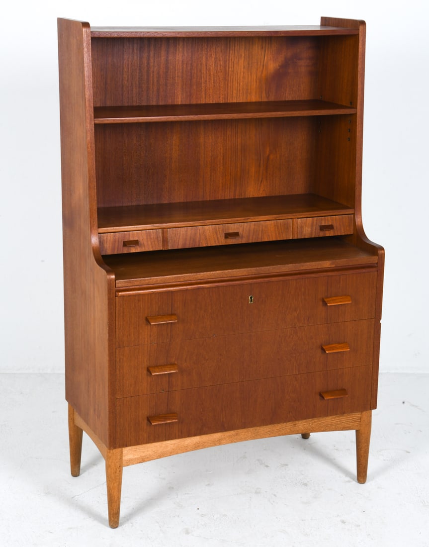 DANISH TEAK SCRETARY DESK BOOKSHELF C. 1960S: Key included. Secretary desk with pull out desk. Adjustable shelves. Denmark, circa 1960s. Dimensions: H 53.5" x W 33" x D 16". Pull Out Desk D 15". Condition: Wear consistent with age and use. Minor