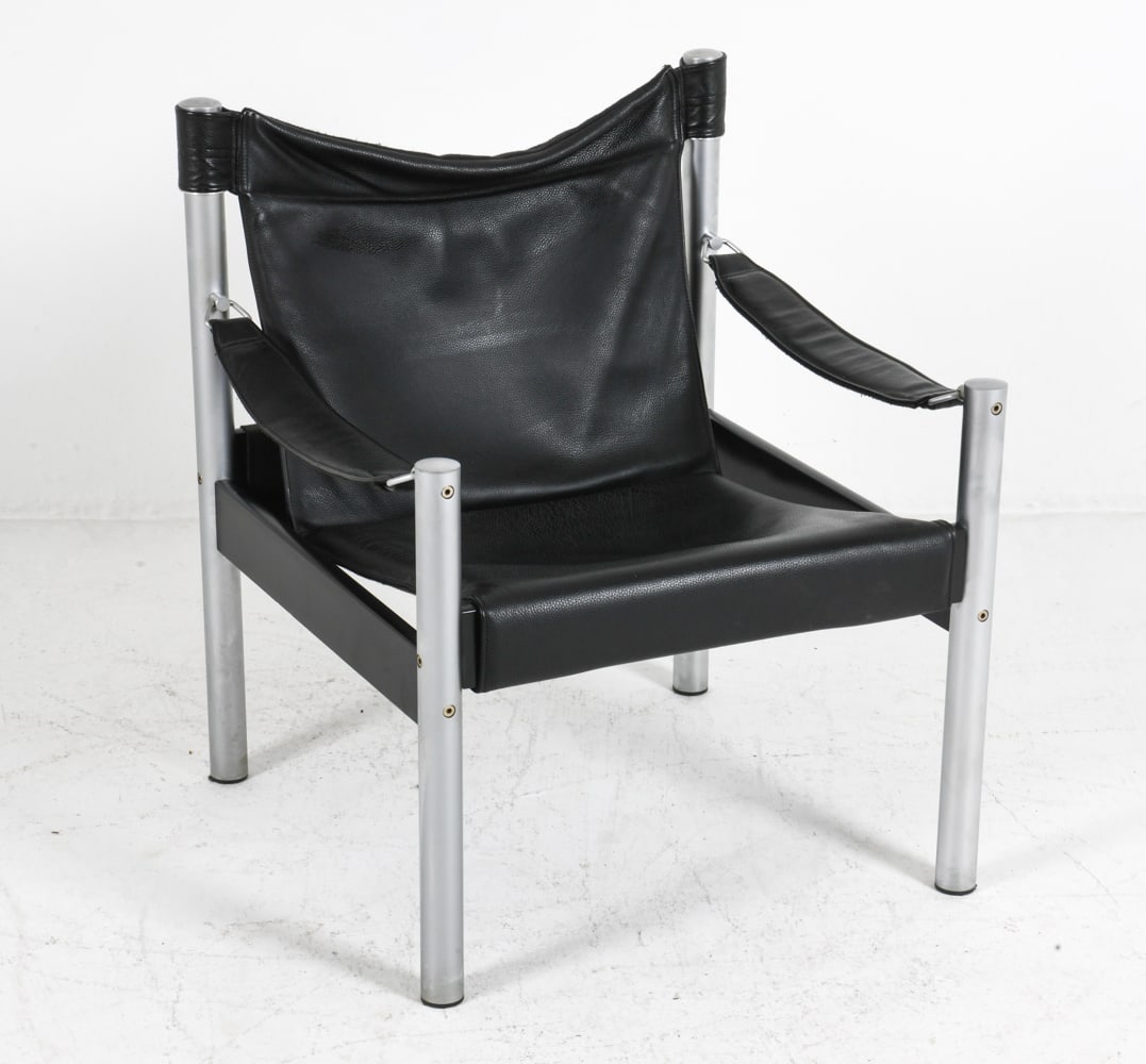 ATTR. BORJE JOHANSON BLACK LEATHER SAFARI CHAIR: Safari chair attributed to Borje Johanson. featuring leather upholstery and chrome frame. Sweden, circa 1970s. Dimensions: H 30" x W 25" x D 24" x SH 16" Condition: Scuffs, rubbing to upholstery, scra