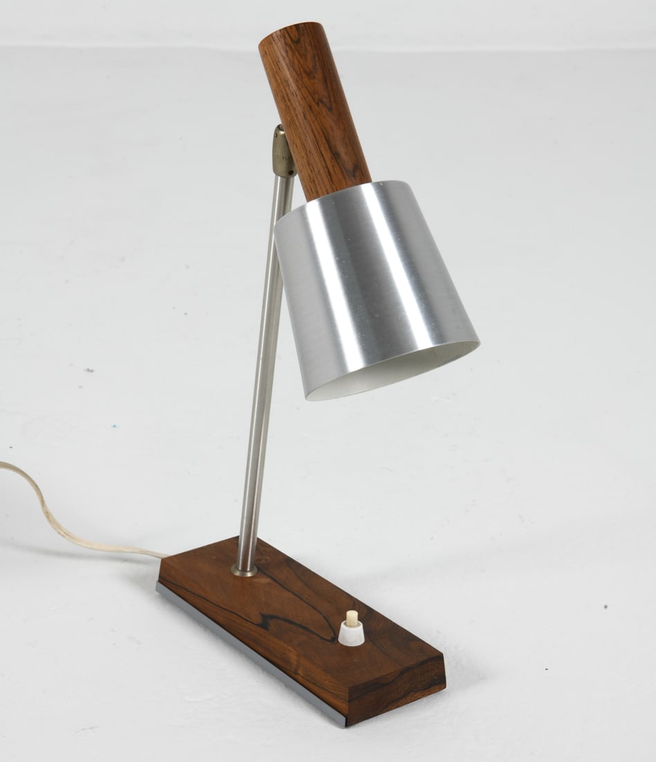 LYFA 'SILVA' ROSEWOOD DESK LAMP C. 1960S: Rosewood to base and top with brushed aluminum. Apparently unmarked. Denmark, circa 1960s. Dimensions: H 14" x W 7.5" x D 3.75". Condition: Wiring untested, cord cut. Minor scuffs. Wear consistent wit
