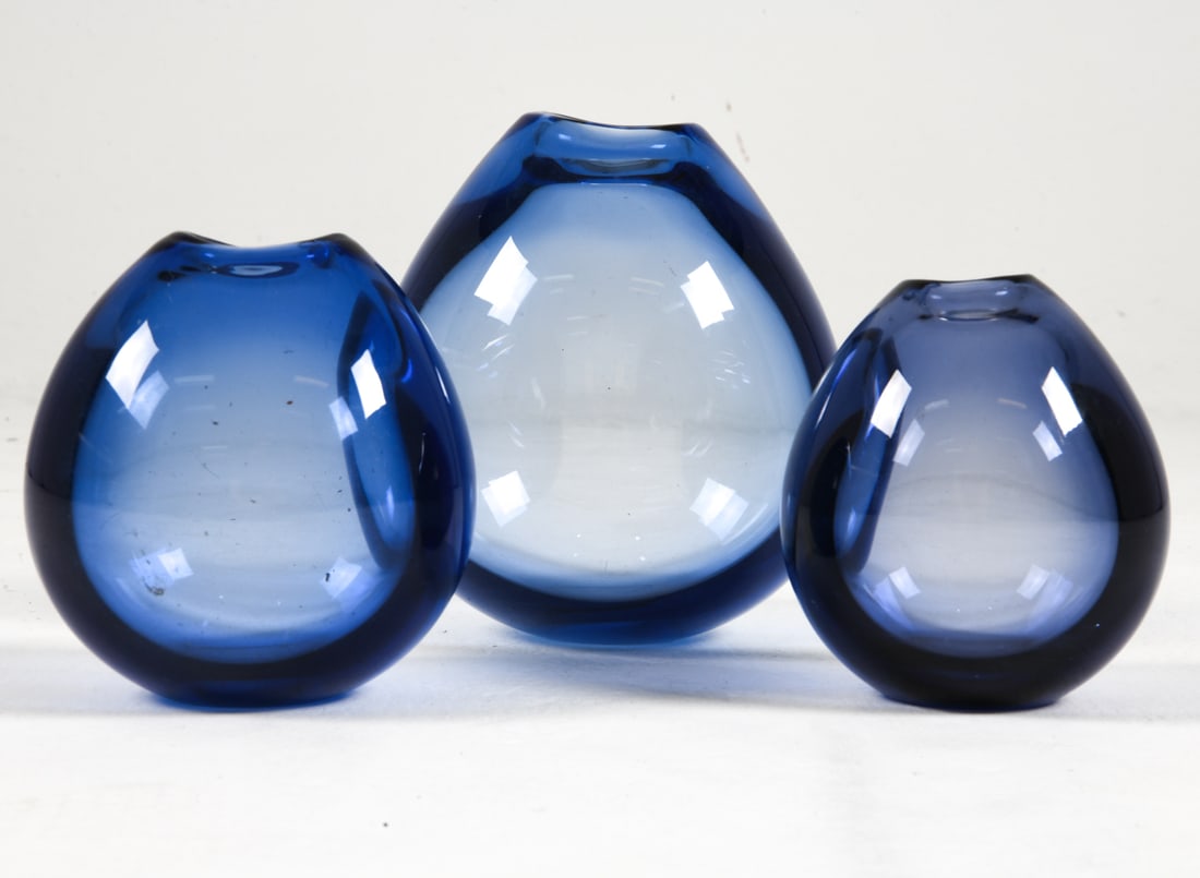 PER LUTKEN HOLMEGAARD GLASS VASE GROUPING 1960S: Grouping of (3) blue glass vases. Signed underneath. Denmark, circa 1960s. Dimensions: Largest H 7.5". Condition: Minor scuffs and thin surface scratches. Wear consistent with age and use.