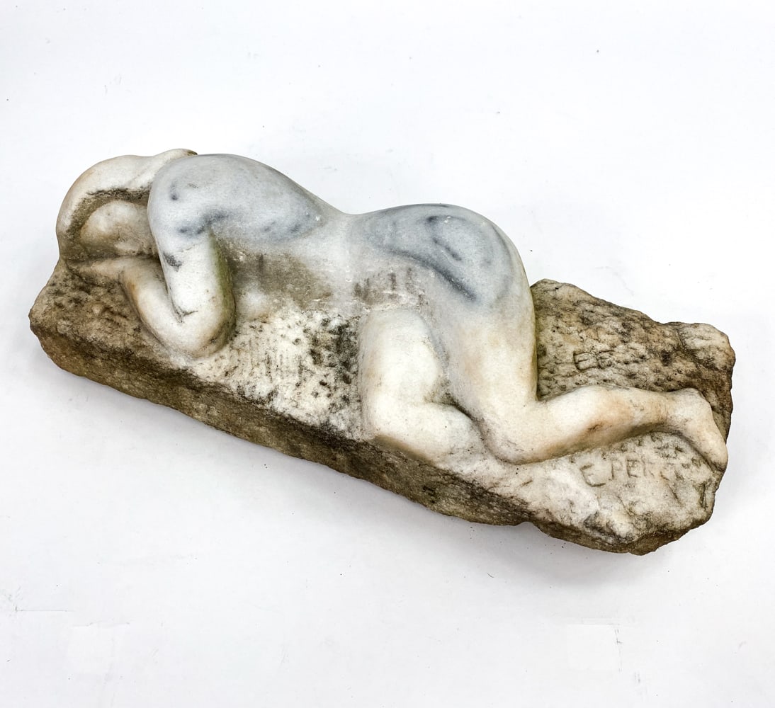 ESER PERCY MARBLE SCULPTURE OF NUDE WOMAN: Features a nude woman laying down. Signed on base E. Percy. Dimensions: H 5" x W 17" x D 6.5" Condition: Wear from being outside, including spots of discoloration, surface marks, and small losses, con