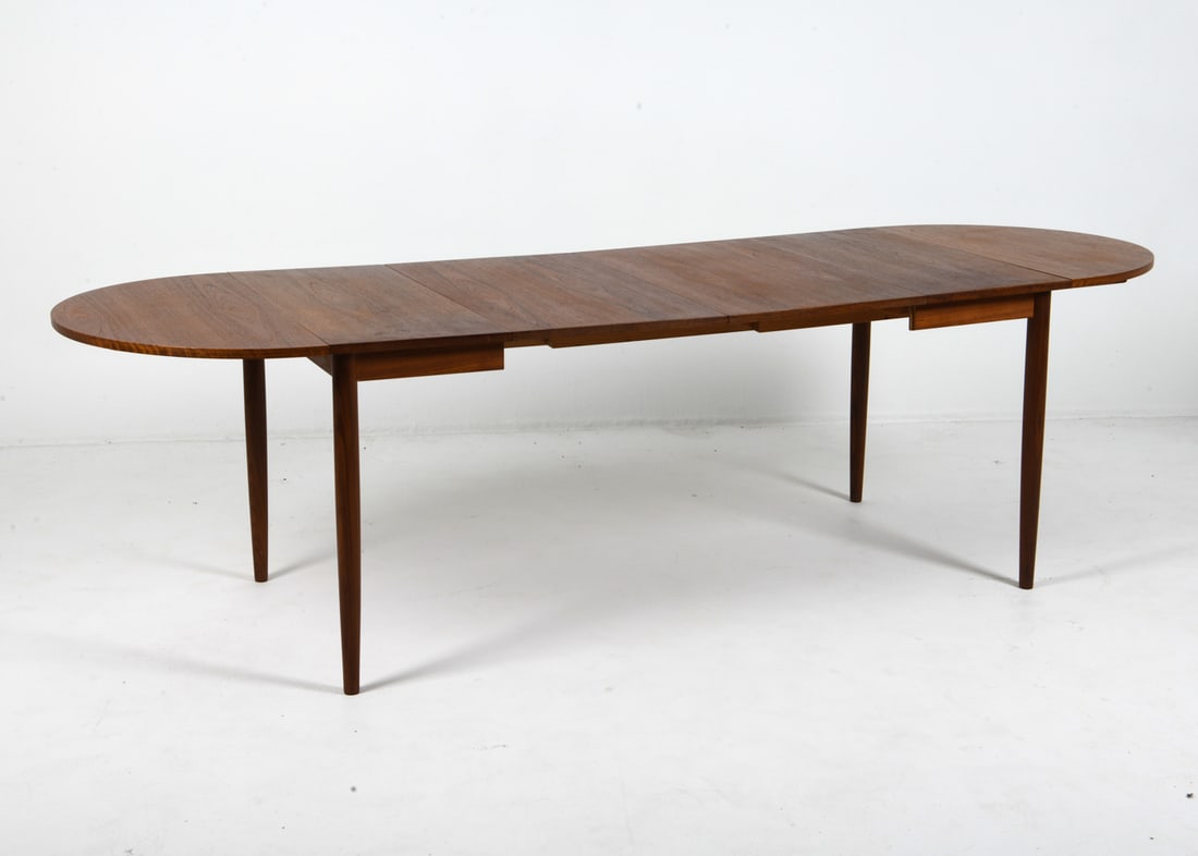 ARNE VODDER TEAK EXTENDING DINING TABLE C. 1960S: (2) Leaves included, along with (2) drop leaves. Apparently unmarked. Denmark, circa 1960s. Dimensions: H 28.5" x W 29" x D 33.5". Leaves W 18.75". Condition: Minor scuffs and rubs, mostly to legs. We