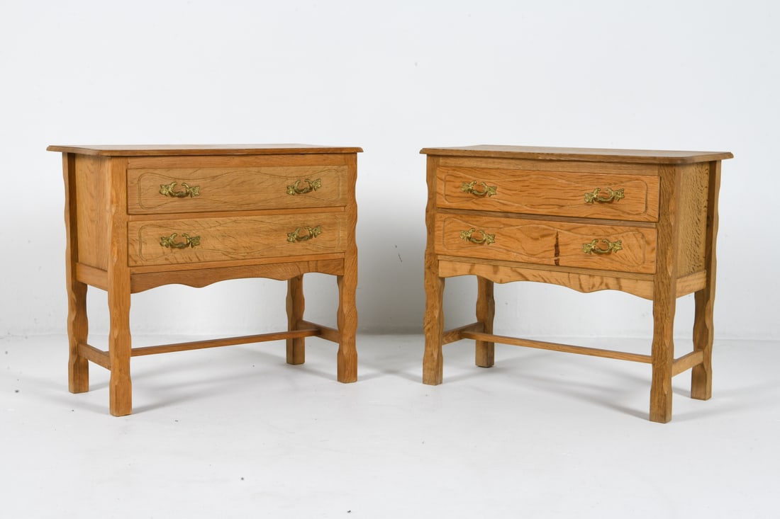 STYLE OF HENNING KJAERNULF OAK SIDE CHESTS C 1970S: Pair of oak chests with brass pulls to drawers. Denmark, circa 1970s. Dimensions: H 23.5" x W 26.75" x D 13.25". Condition: Discolored streak to drawer front of one. Wear consistent with age and use.