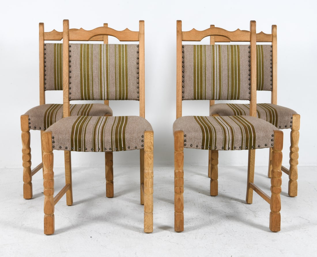 (4) STYLE OF HENNING KAJERNULF OAK DINING CHAIRS: Oak frames with turned legs and wool upholstery with brass tacks accents. Denmark, circa 1970s. Dimensions: H 37" x W 16" x D 18" x SH 18". Condition: Scuffs and rubs to legs. Wear consistent with age
