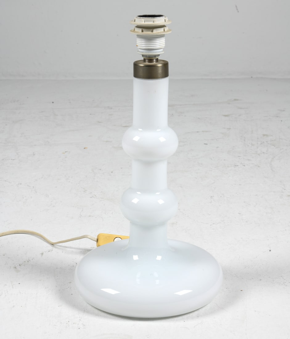 HOLMEGAARD WHITE OPALINE GLASS TABLE LAMP C. 1970S: Mandarin Opal Model lamp by Holmegaard. Denmark, circa 1970s. Dimensions: H 16.5" x Dia. 8.5". Condition: Wiring untested, European plug. Few minor scuffs. Wear consistent with age and use.
