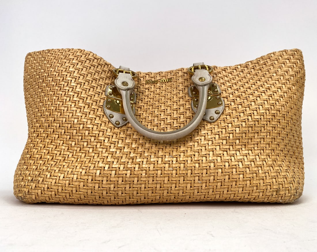 MIU MIU BEIGE RAFFIA HANDBAG L: Miu Miu basket style handbag with gold-tone hardware and leather handles. The woven material is raffia with logo on the front. Size L. Dimensions: H 15" x W 22" x D 5" Condition: Scuffs, rubbing, sign