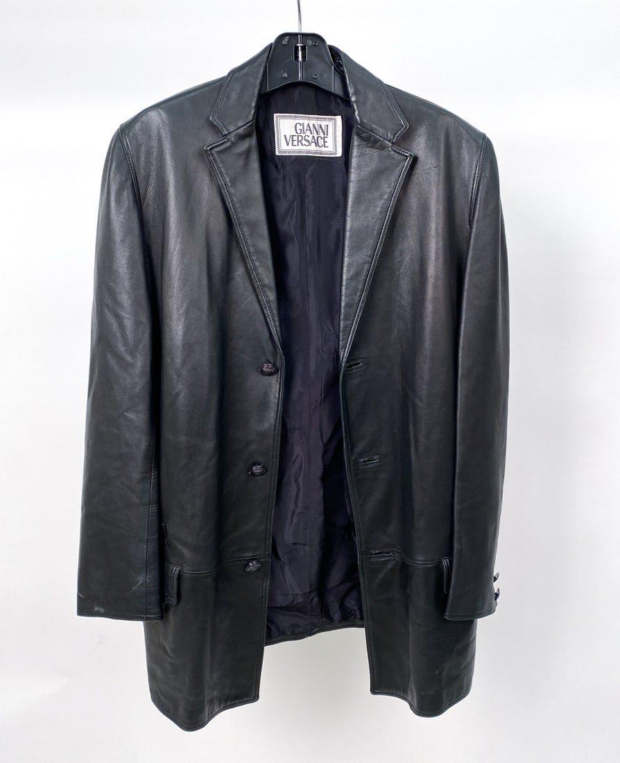 GIANNI VERSACE BLACK LEATHER JACKET: Men's three-button black lambskin leather jacket by Gianni Versace. Label to neck. #60VEW-036 Size: IT 48 Condition: Minor creasing to leather & rubbing. Few small cuts to bottom of right sleeve. Wear