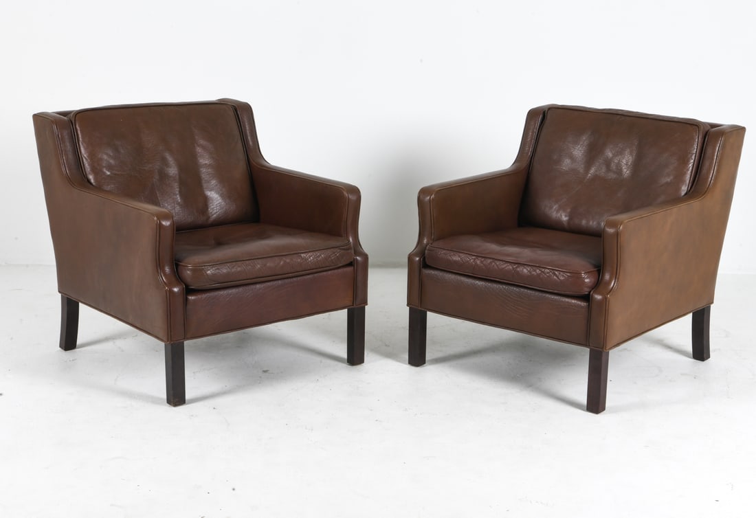 PAIR OF BORGE MOGENSEN STYLE LEATHER LOUNGE CHAIRS: Brown leather upholstery with beech legs. Denmark, circa 1970s. Dimensions: H 29.5" x W 27.75" x D 31.5" x Sh 16.25". Condition: Wear consistent with age and use, including rubs and dings. Small dents
