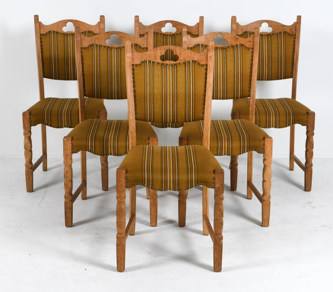 (6) HENNING KJAERNULF STYLE OAK DINING CHAIRS: Oak frames with wool upholstery. Trefoil cut-out design to seat backs. Denmark, circa 1970s. Dimensions: H 37.5" x W 18" x D 18" x SH 18.5". Condition: Minor scuffs to wood, wear consistent with age a
