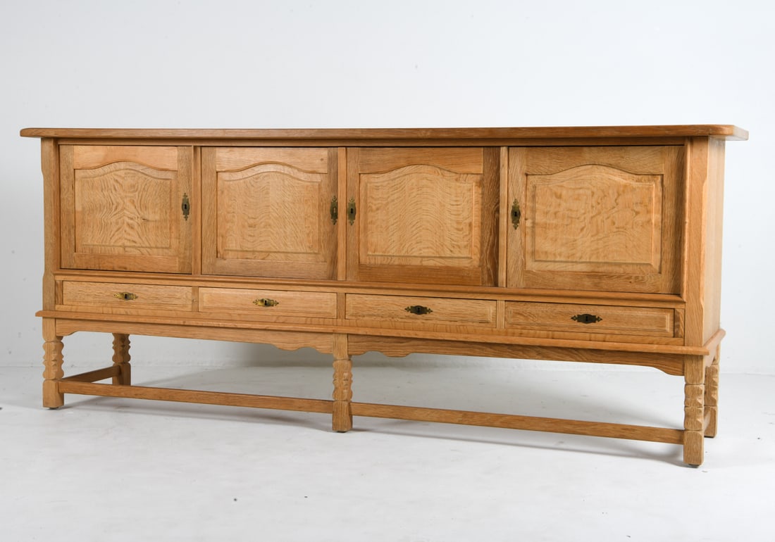 HENNING KJAERNULF DANISH OAK SIDEBOARD C. 1960S: Key included. Tagged "Stilmobler" on the back. Denmark, circa 1960s. Dimensions: H 36.5" x W 88.5" x D 20". Condition: Wear consistent with age and use, including rubs. EN026