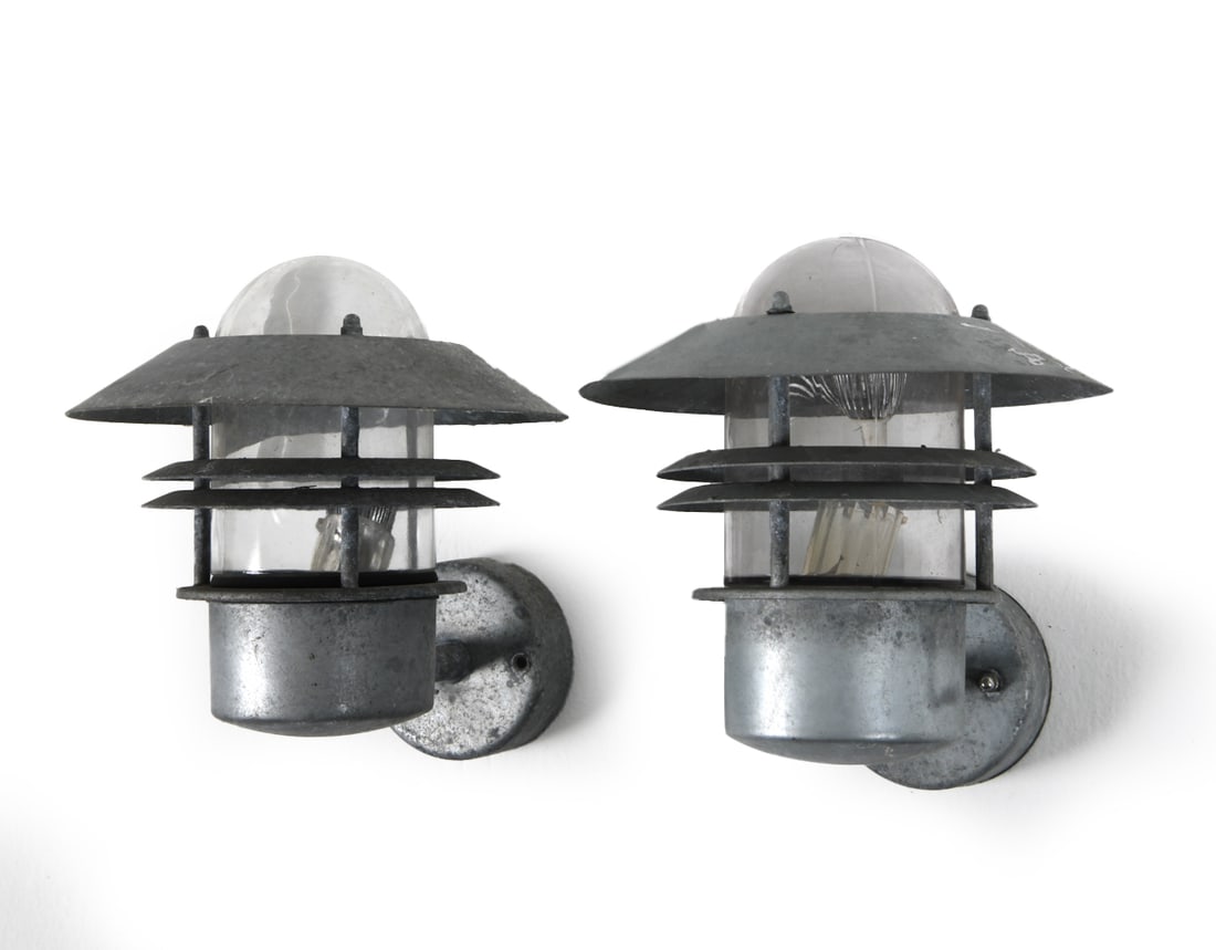 PAIR OF NORDLUX GALVANIZED STEEL UFO SCONCES 1980S: Galvanized steel sconces with glass cylindrical globes. Apparently unmarked. Denmark, circa 1980s. Dimensions: H 10" x W 8.5" x D 8.5" Condition: Untested. Oxidation from being outside. Wear consisten