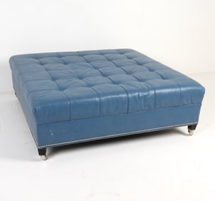 Blue tone leather with silver tone tacks. On metal casters. Dimensions: H 17" x W 49.5" x D 49.5"