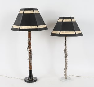2 lamps crafted from a flute and Corton Clarinet. Shades with music note patterns.