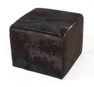 Ottoman upholstered in black cow's hide. Dimensions: H 20" x W 15.5" x D 15.5". Condition: Some