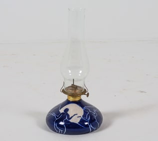 Ceramic base with nude figures. Signed indistinctly under base. Dimensions: H 15" x Dia. 6.5".