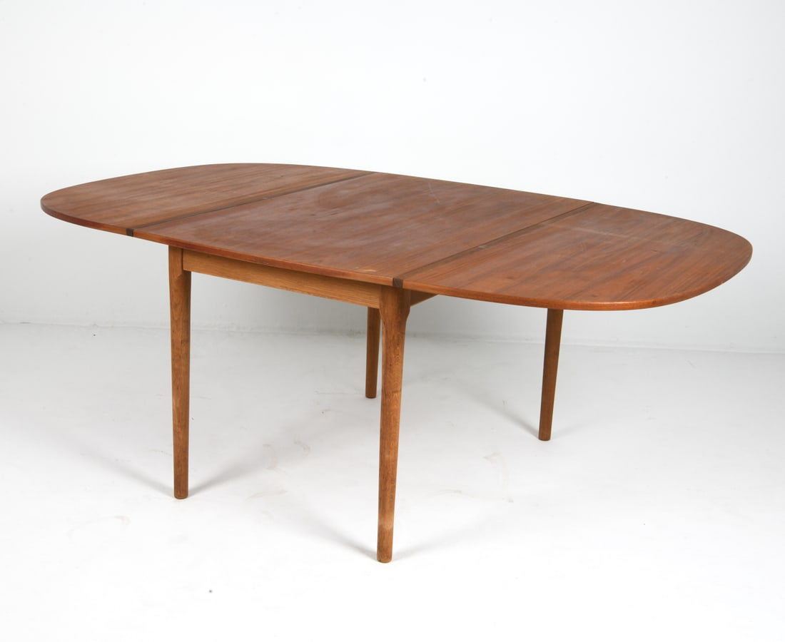 ATTR ARNE VODDER TEAK DROP-LEAF DINING TABLE 1960S: (2) Drop leaves. Denmark, circa 1960s. Dimensions: H 30" x W 29.75" x D 46.75". Leaves W 22.75". Condition: Minor scuffs and scratches, wear consistent with age and use. Good presentation overall. PER