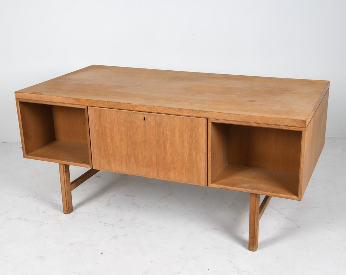OMANN JUN MODEL 76 FREESTANDING OAK DESK C. 1960S: (3) Keys included. Denmark, circa 1960s. Dimensions: H 28.5" x W 61.5" x D 31". Condition: Wear consistent with age and use including dings and scratches, losses to surface to lefts drawers. PERG039