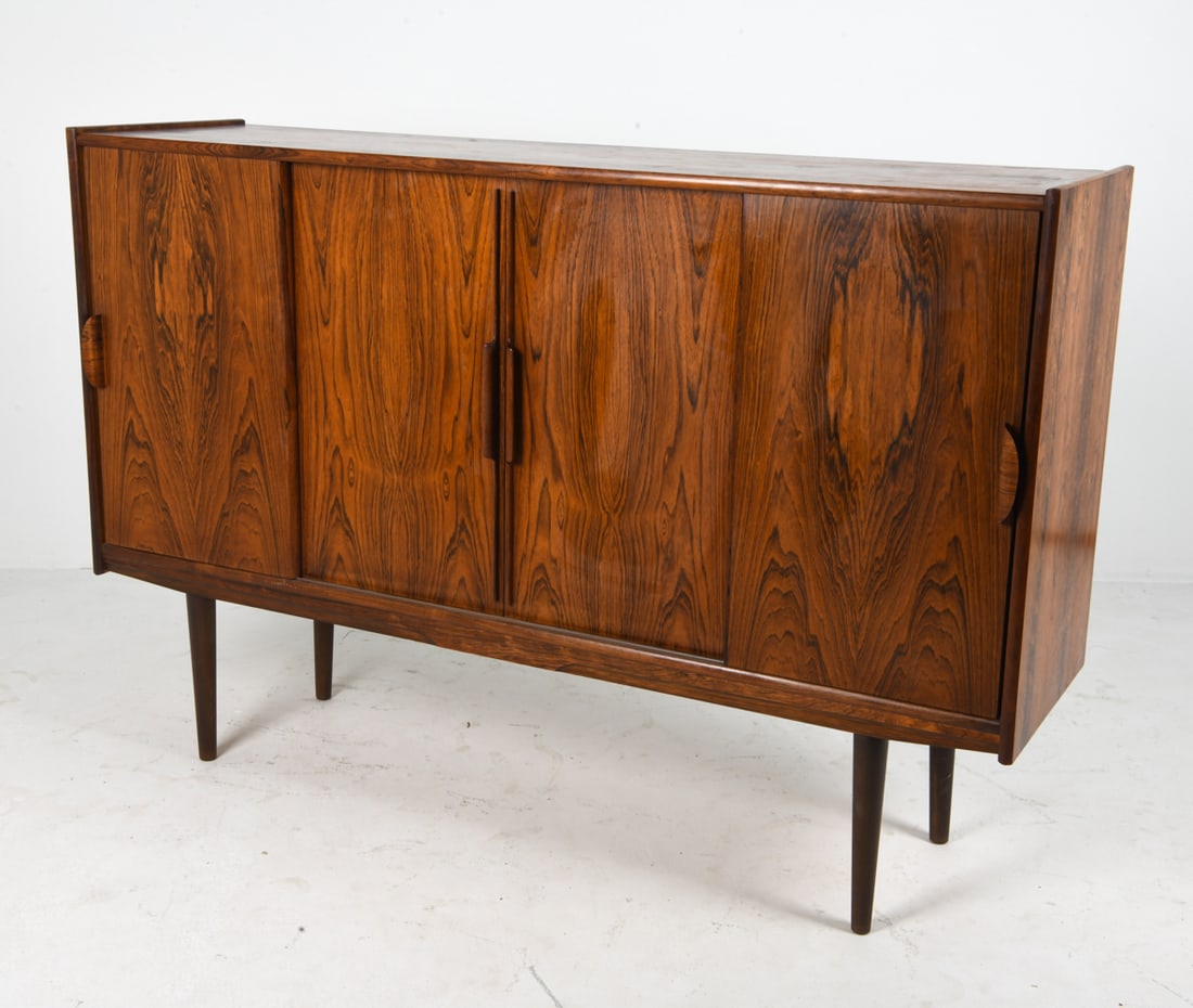 OMANN JUN STYLE DANISH ROSEWOOD SIDEBOARD C. 1960S: Lighted bar cabinet to center space with frosted mirror. Adjustable shelves. Felt lined drawers. Denmark, circa 1960s. Dimensions: H 46.5" x W 68.5" x D 18.5". Condition: Water spots to top. Few scuff
