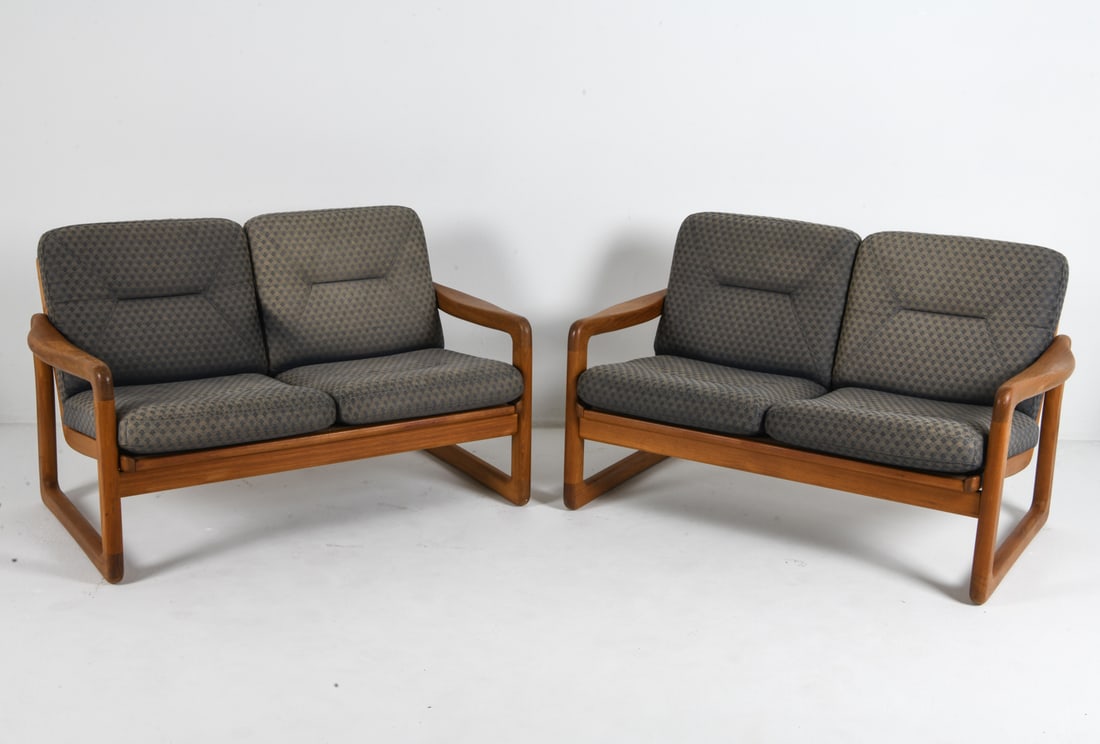 PAIR OF HOLSTEBRO DANISH TEAK SOFAS: Teak frames with patterned fabric cushions. Tagged underneath to frame. Denmark, circa 1960s. Dimensions: H 31.25" x W 49.5" x D 27" x SH 17". Condition: Minor scuffs to frame. Wear consistent with ag