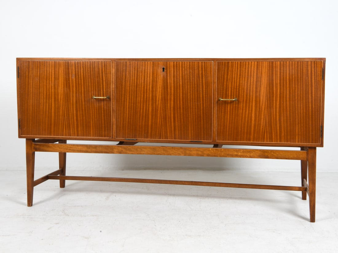 MOBELEXPORTEN DANISH MAHOGANY SIDEBOARD C. 1970S: Key included. Model 119. Stamped to back. Adjustable shelves. Brass pulls. Denmark, circa 1970s. Dimensions: H 31.5" x W 61" x D 19.75". Condition: Few scuffs and scratches to door fronts. Wear consis