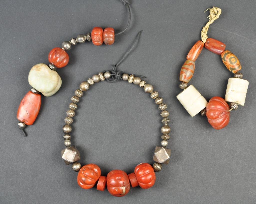 CARVED CARNELIAN BEADED JEWELRY: Along with other stones, coral, and silver beads. Dimensions: all in varied sizes. Condition: very good