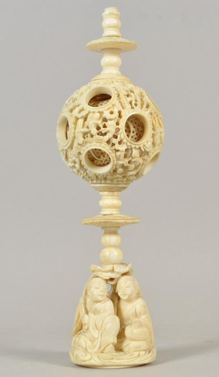 19TH C. CHINESE IVORY PUZZLE BALL: Note: The elephant ivory used in this lot was legally imported into the United States in the late 19th century. This item will only be shipped domestically. Dimensions: H 7" x W 2" x D 3/4" Condition: