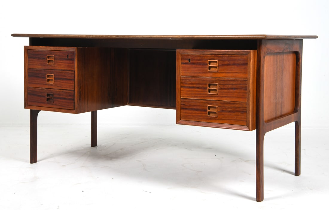 ARNE VODDER DANISH ROSEWOOD DESK C. 1960S: For Brouer Mobelfabrik. Featuring a floating top, sculpted legs and integrated pull handles. Apparently unmarked. Denmark, circa 1960s. Dimensions: H 28" x W 56.75" x D 29.25" Condition: Wear consiste