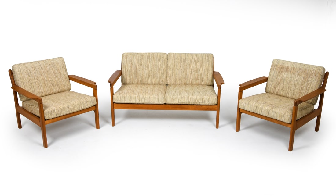 KOMFORT DANISH TEAK SOFA & LOUNGE CHAIRS C. 1970S: Includes (1) two-seater sofa and (2) lounge chairs. Teak frames with cushions. Tagged underneath to frames. Denmark, circa 1970s. Dimensions: Sofa H 29" x W 50.75" x D 27.5" x SH 13.75". Chairs H 26"