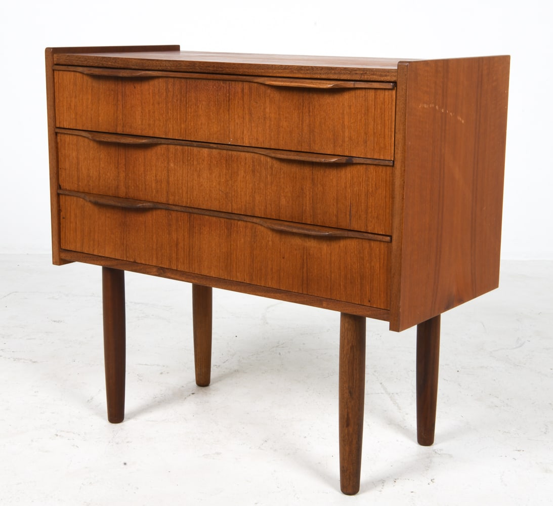 DANISH TEAK NIGHTSTAND CHEST C. 1960S: Denmark, circa 1960s. Dimensions: H 24.5" x W 25.5" x D 12". Condition: Some sun fading and water spots to top, few scuffs. Wear consistent with age and use.