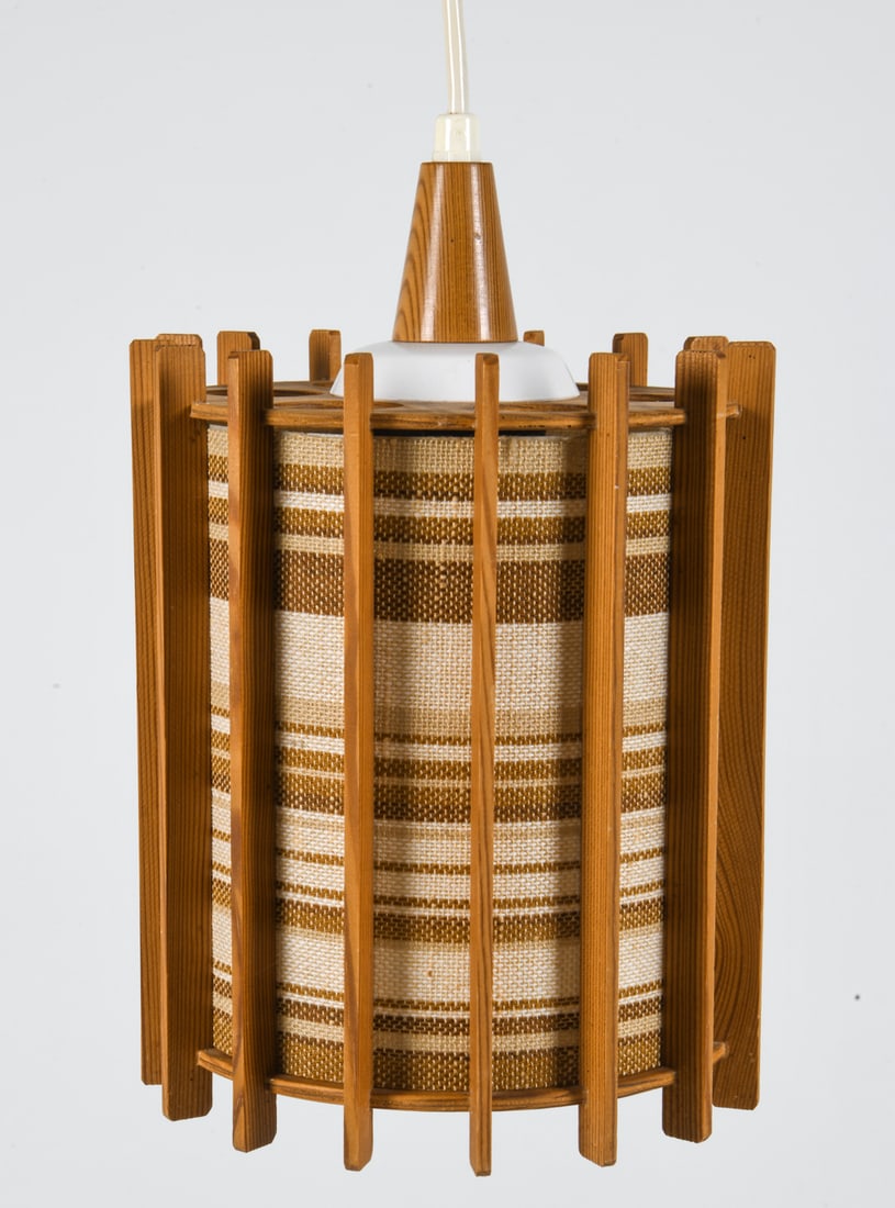 SWEDISH PINE & FABRIC PENDANT LIGHT C. 1970S: Pendant light with pine slats and fabric wrapped interior shade. Sweden, circa 1970s. Dimensions: H 9" x Dia. 7.25". Condition: Wiring untested. Few scuffs to wood. Wear consistent with age and use.