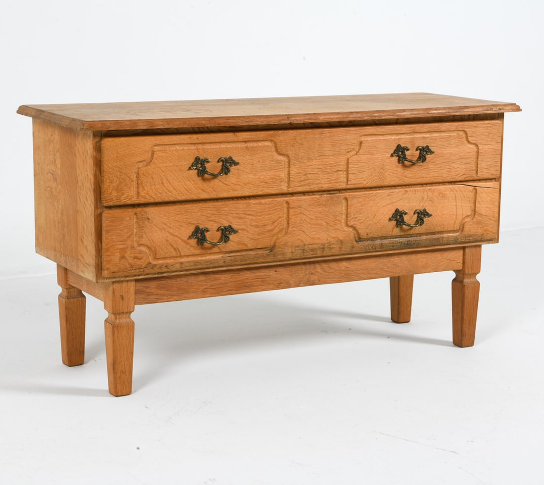 ATTR. HENNING KJAERNULF DANISH OAK LOW CHEST: Small low chest with carved decoration to drawer fronts. Brass drawer pulls. Denmark, circa 1970s. Dimensions: H 20" x W 36" x D 13" Condition: Light dings and scuffs, wear consistent with age and use