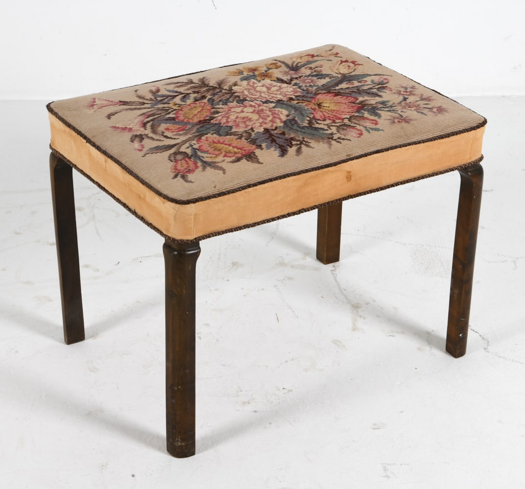 SCANDINAVIAN BEECH & NEEDLEWORK STOOL: Beech legs with floral needlework upholstery. Scandinavian, circa 1930s. Dimensions: H 18.5" x W 24" x D 18". Condition: Scuffs and scratches to legs. Few rubs and tears to fabric. Wear consistent wit