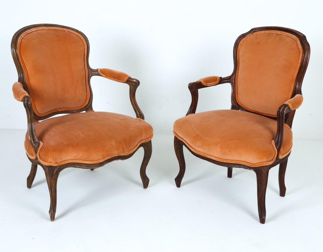 PAIR OF LOUIS XV STYLE VELOUR PARLOUR CHAIRS: Carved mahogany frames with orange velour upholstery. Circa 1940s. Dimensions: H 33.5" x W 27.5" x D 17.5" x SH 16". Condition: Scuffs, rubs, and dings to wood. Slight fading to fabric. Chips to wood,